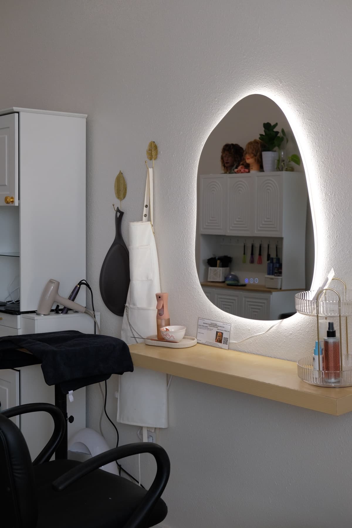 Private styling chair and lighted mirror at Cosmos Studio Titusville